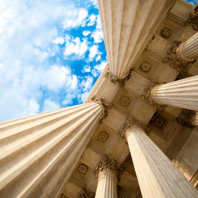 pillars and blue sky with clouds
