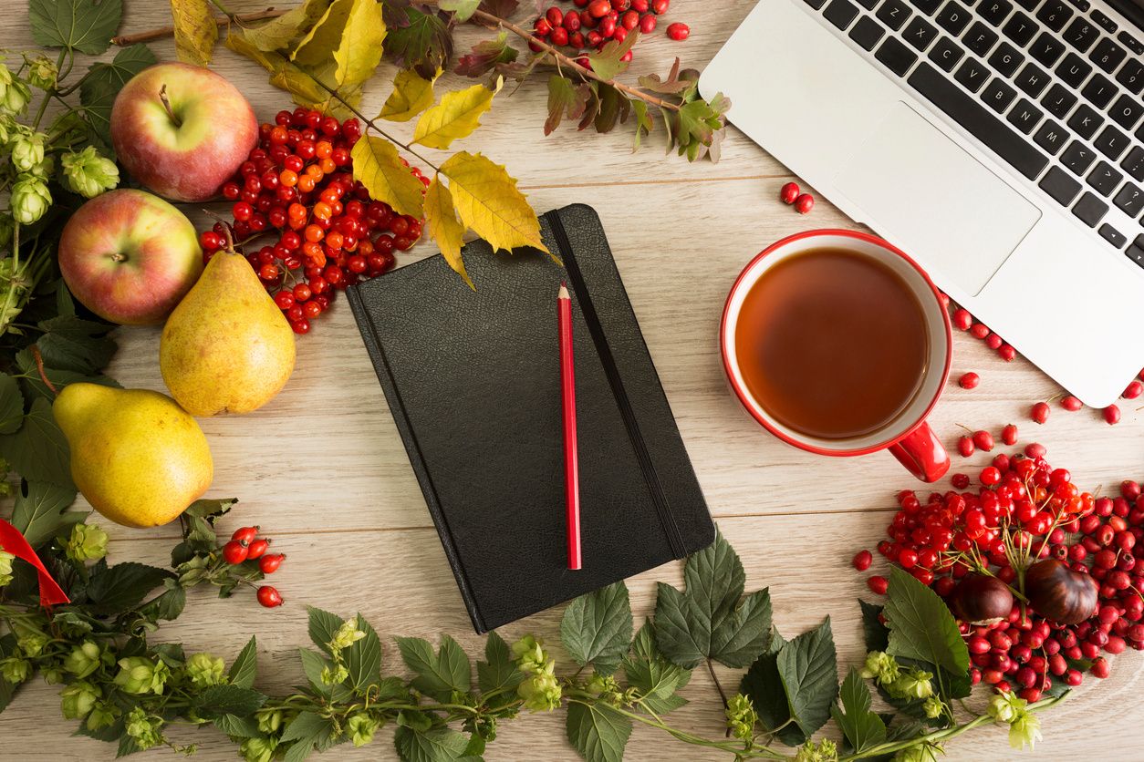 laptop and notebook with holiday decorations