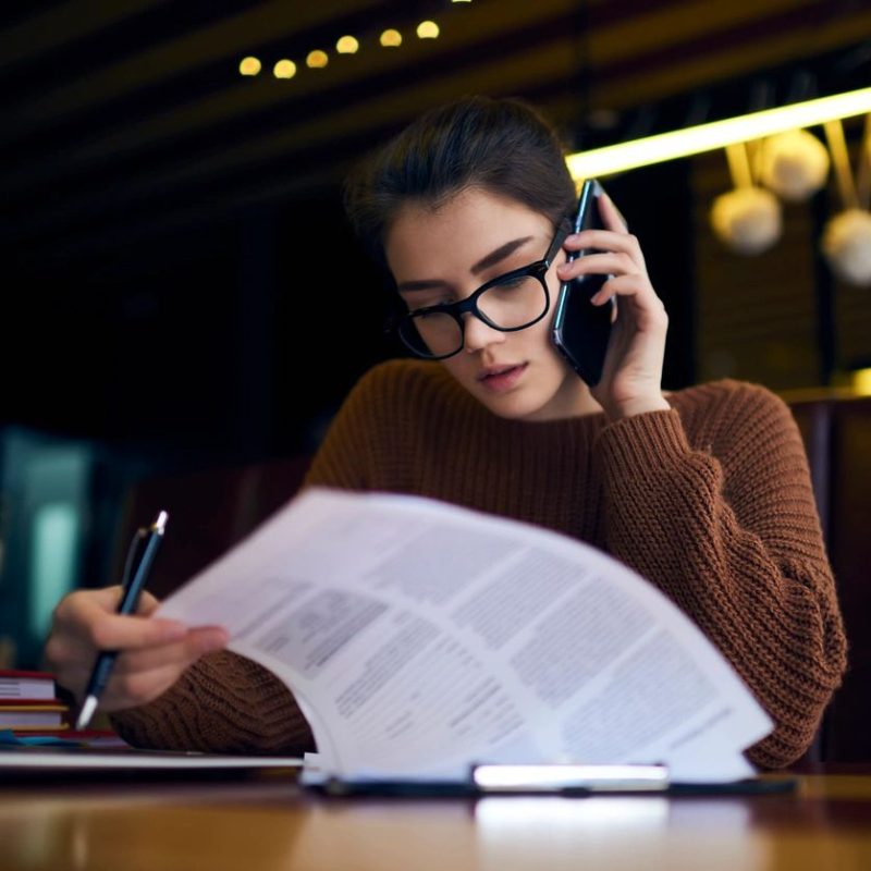 Business person reviewing contract papers