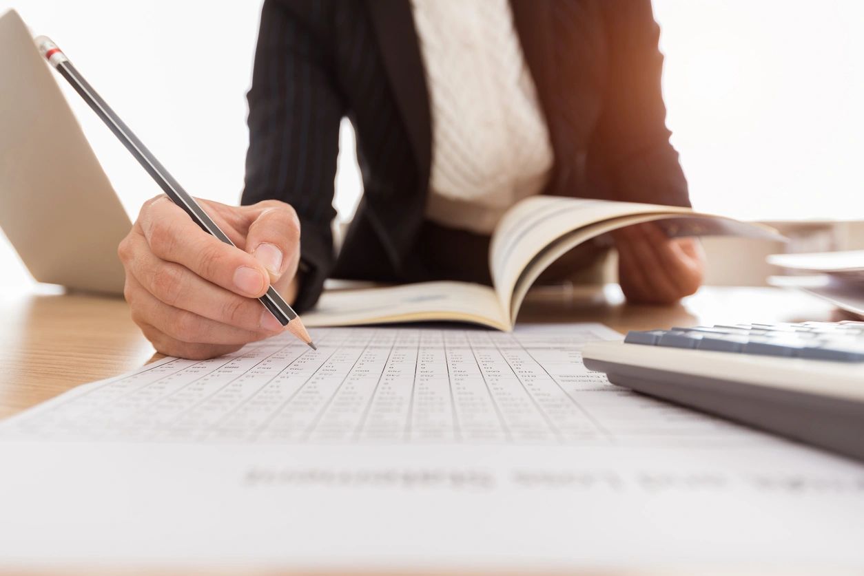 Business person writing on paper