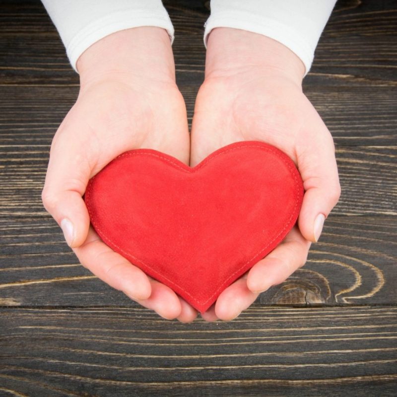 Person holding a red heart shape